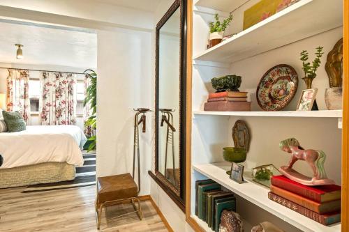 a room with a mirror and a bedroom with a bed at Chickadee Suite in Cashmere
