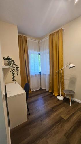 a living room with a desk and a window at Little Bucharest downtown apartments Romana in Bucharest