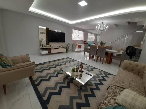 a living room with a couch and a table at Casa para COP 30 in Belém