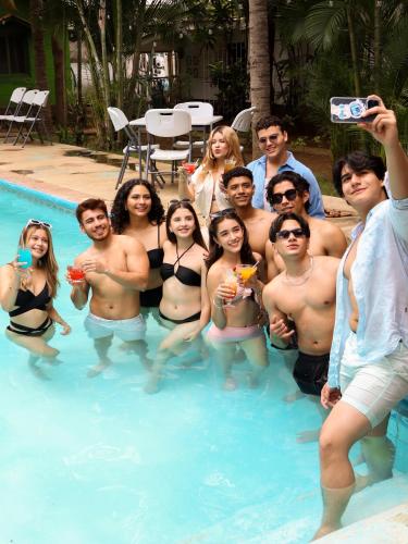 a group of people posing in a swimming pool at La Palmera Dorada in Managua