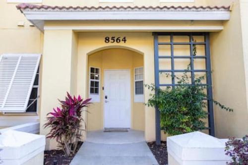 a front door of a building with a white door at Emerald Island Resort townhouse 3 Bedrooms in Kissimmee