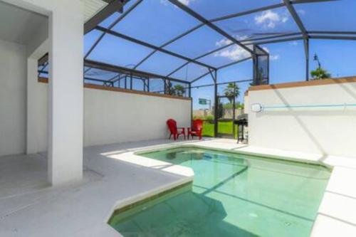 an indoor swimming pool with a glass roof at 4 Bedrooms3 Bathrooms at Storey Lake Resort in Kissimmee