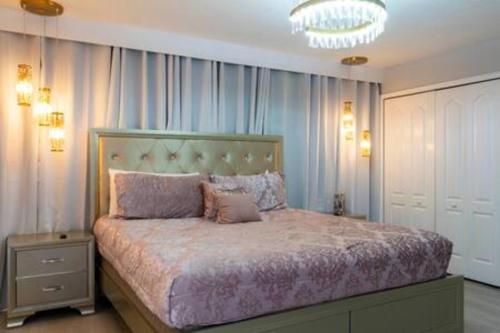a bedroom with a large bed and a chandelier at 4 Bedrooms3 Bathrooms at Storey Lake Resort in Kissimmee