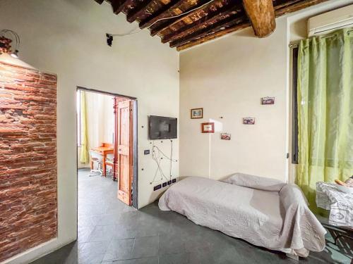 a bedroom with a bed and a window and a table at lovingenoa Iter - Nos in Genoa