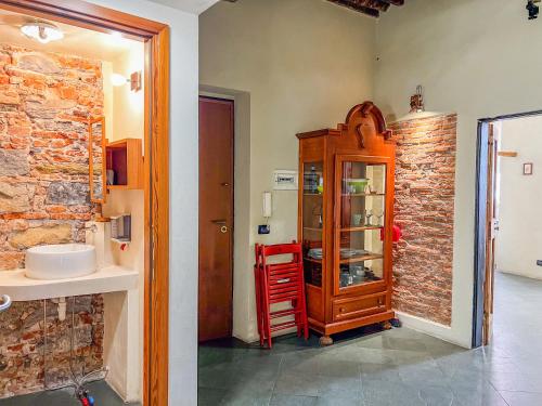 a bathroom with a sink and a wooden cabinet at lovingenoa Iter - Nos in Genoa
