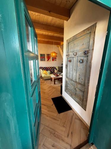 a hallway with a door and a living room at Apartmán Stela in Spišské Tomášovce
