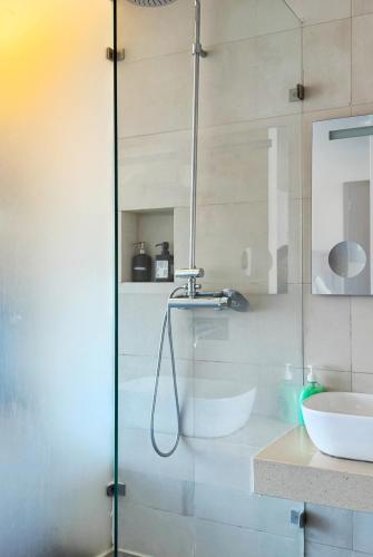a glass shower in a bathroom with a sink at republica83-Lisbonhome in Lisbon