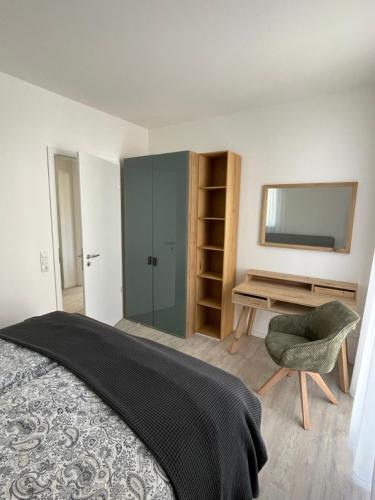 a bedroom with a bed and a desk and a mirror at Appartement Sonnenblume in Spangenberg