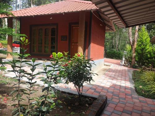 a small house with a plant in front of it at Todo estate stay coorg in Suntikoppa