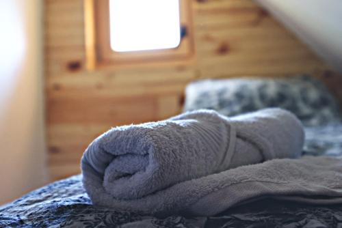 a towel is sitting on top of a bed at Kanjon 987 in Podgrad