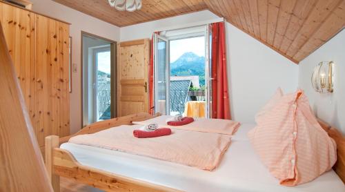 a bedroom with a bed with red slippers on it at Gästehaus Lutschounig in Faak am See