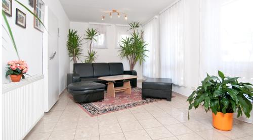 a living room with a couch and a table at Gästehaus Lutschounig in Faak am See
