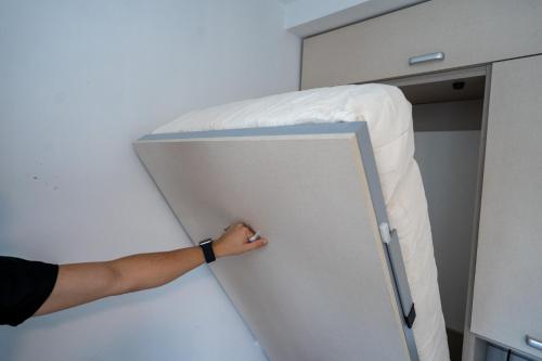 a person is holding a bed in a room at Complejo Turistico Open Club in Paraná