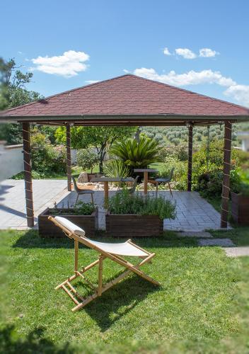 a gazebo with a bench and a table at GinKgo B&B in Francavilla al Mare