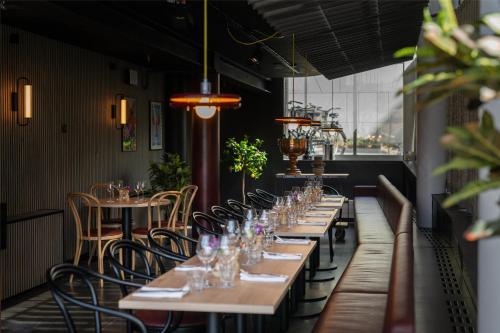 a row of tables in a restaurant with glasses at Radisson Blu Hotel Uppsala in Uppsala