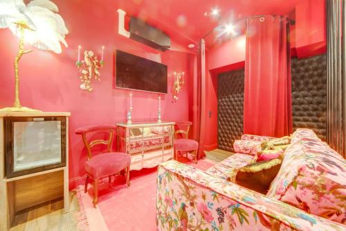 un salon avec un canapé et une télévision dans l'établissement Love & Room SPA Week-End, à Paris