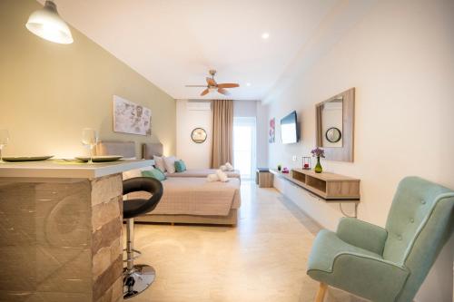 a bedroom with a bed and a couch and a chair at Diamond Apartments 4 in Kardamaina