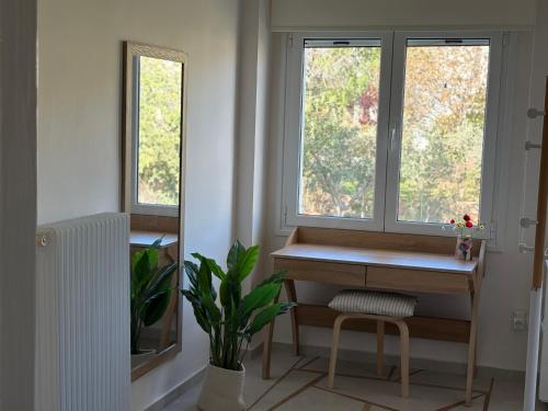 a home office with a desk and two windows at Stunning Seaview Apartment in Mati, Nea Makri in Nea Makri