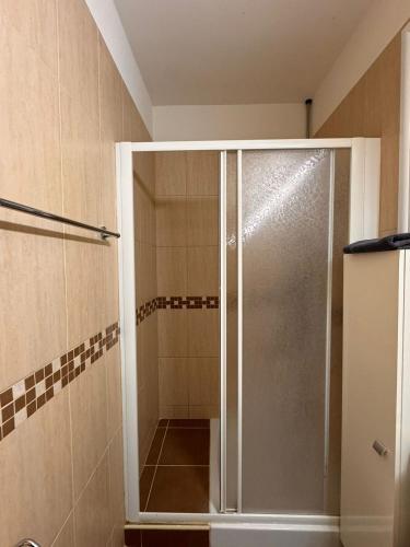 a shower with a glass door in a bathroom at Tersefanou Retreat in Tersephanou