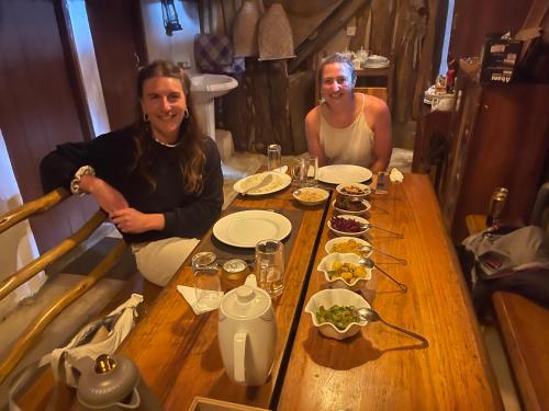 two people sitting at a table with food on it at The Lake Frost in Nuwara Eliya