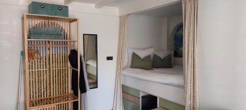 a mirror in front of a bedroom with a bed at Zeelucht in Zandvoort