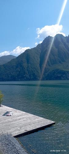 a rainbow over a lake with a wooden dock at Casa Caterina - Riva di Solto - Iseo Lake in Riva di Solto