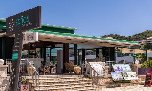 a restaurant with a sign in front of it at Sofia's Hotel in Kalamaki