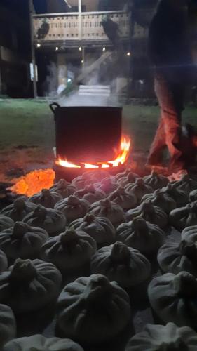 a herd of sheep are standing around a fire at Lia Jamdeliani Guest House in Mazeri