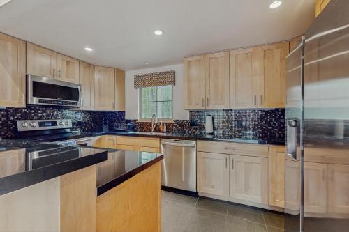 a large kitchen with wooden cabinets and stainless steel appliances at Chic Condo Unit 1 in Aspen