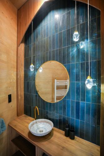 a bathroom with a sink and a mirror at Villa Marrakesh Noszvaj in Noszvaj