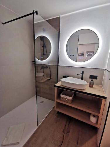 a bathroom with a shower and a sink and a mirror at Pension Zum Stellmacher in Beelitz