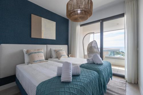 a bedroom with two beds and a large window at Casa El EDEN 39 in Mijas