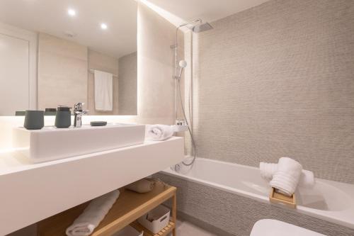 a bathroom with a white sink and a tub at Casa El EDEN 39 in Mijas
