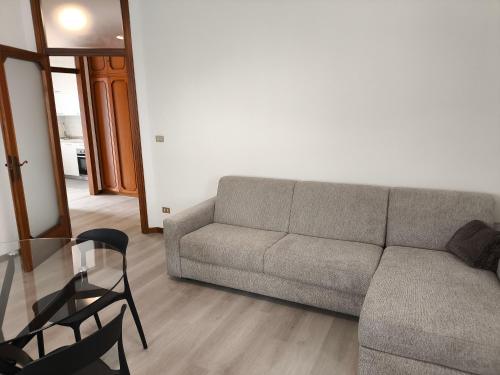 a living room with a couch and a chair at Dormire Negrar in Negrar