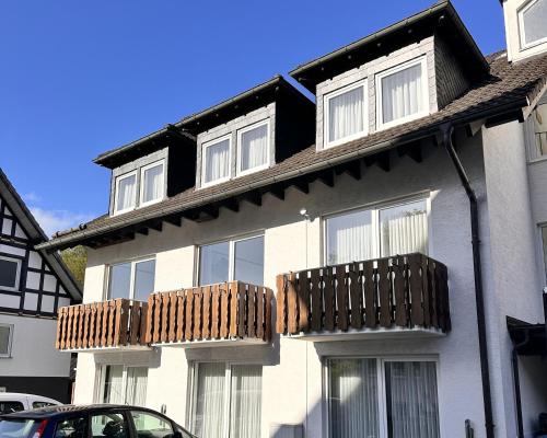 a white house with windows and a balcony at Smart Resorts B&B 2 BB2 324 in Winterberg