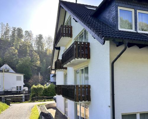 a white house with balconies and a street at Smart Resorts B&B 2 BB2 326 in Winterberg