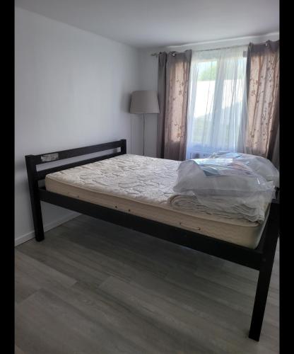 a bed in a room with a window at Appartement cosy proche de la plage in Brétignolles-sur-Mer
