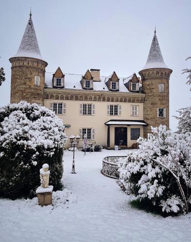 a large castle building with snow on the ground at Château Philip in Saint-Genest-Lerpt