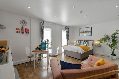 a living room with a bed and a couch at City Centre Studio Apartments - Ashton Apartment - Short Stays UK Ltd in Exeter