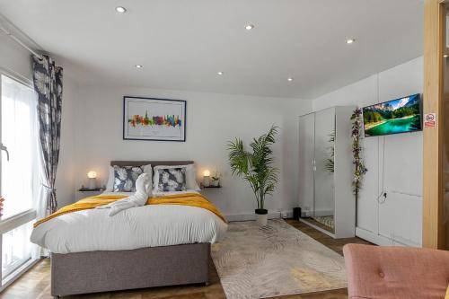 a bedroom with a large bed and a large window at City Centre Studio Apartments - Ashton Apartment - Short Stays UK Ltd in Exeter