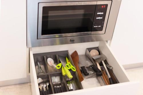 a drawer filled with scissors and other kitchen utensils at Sky Suites KLCC By Star Apartment in Kuala Lumpur