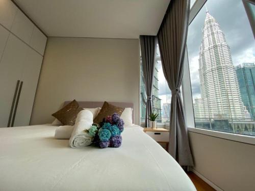a bedroom with a bed with flowers on it at Sky Suites KLCC By Star Apartment in Kuala Lumpur