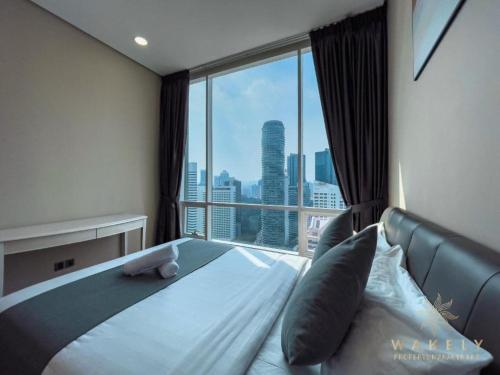 a bedroom with a bed and a large window at Sky Suites KLCC By Star Apartment in Kuala Lumpur
