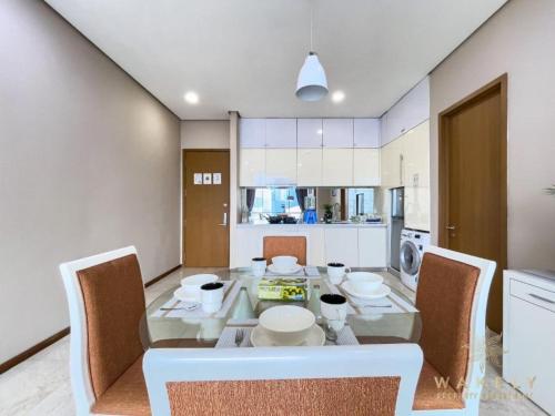 a kitchen and dining room with a table and chairs at Sky Suites KLCC By Star Apartment in Kuala Lumpur
