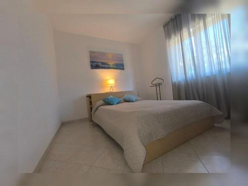 a bedroom with a bed with a lamp on it at Pizzo Beach Club Luxury Apartment in Pizzo