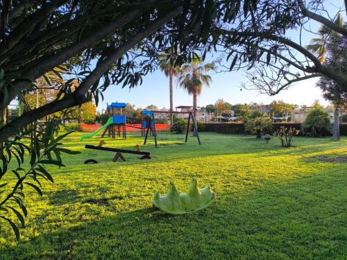 a park with a playground with a banana on the grass at Pizzo Beach Club Luxury Apartment in Pizzo