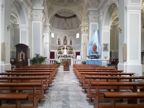 a church with rows of wooden pews in it at ROSALINDA - Borgo Experience Cilento in Casaletto Spartano