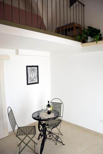 a table and two chairs in a room at Miria B&B in Castrignano del Capo