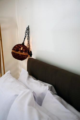 a bedroom with a bed with a basket hanging over it at Miria B&B in Castrignano del Capo