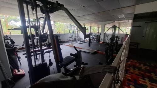 a gym with rows of treadmills and machines at Ecohotel Santa Barbara in Circasia